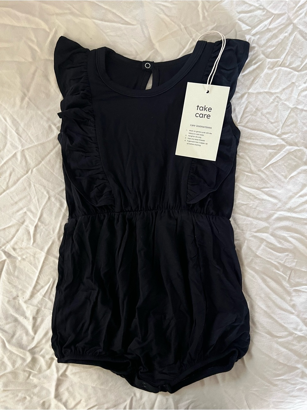 Kyte Baby Black Ruffle Sleeve Baby Romper